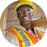 Photo of a skilled tradesperson carrying lumber.