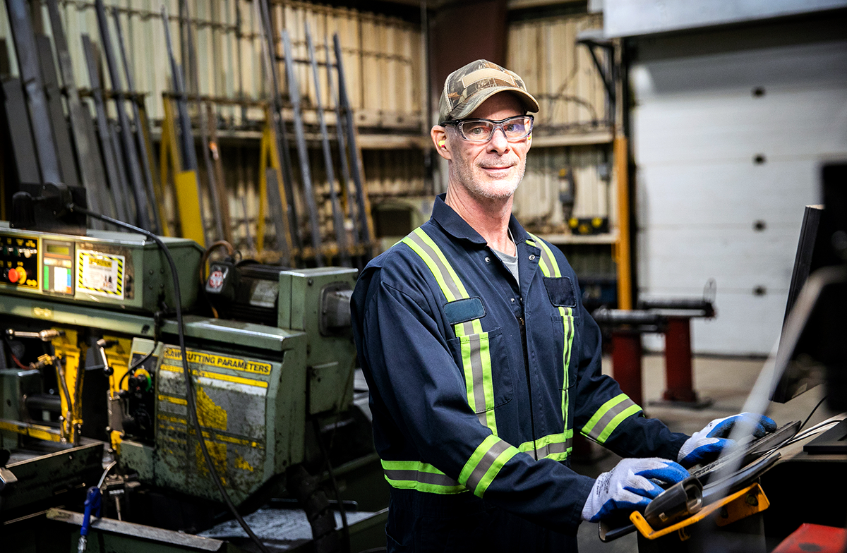Photo of an employee working on equipment in a Mining Machinery Manufacturing Facility in Cambridge, Ontario.