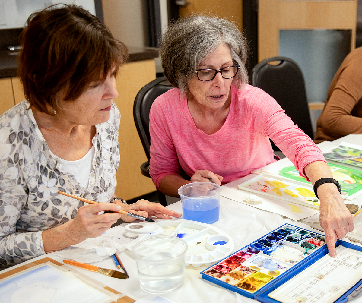 Photo of seniors working on their artwork in a Watercolour Painting class.