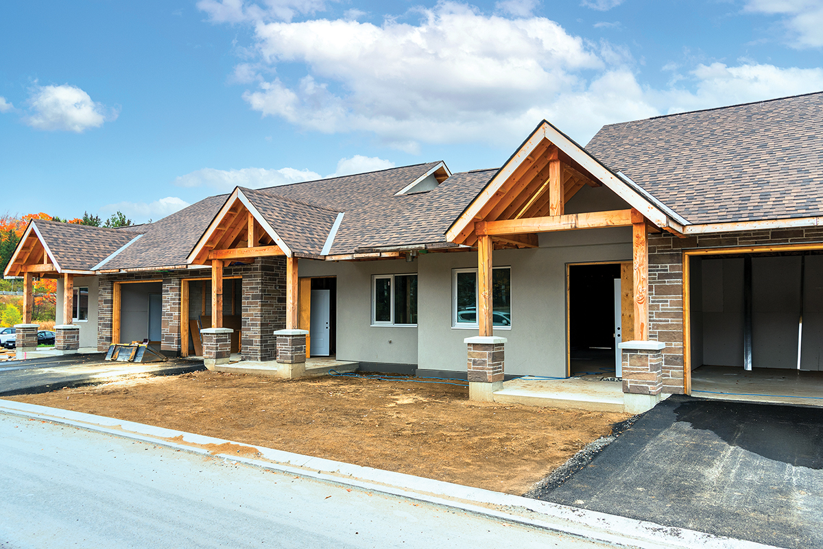 Photo of houses in construction in a housing development site.