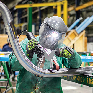 worker welding at nuclear facility