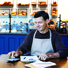 small businees owner doing accounting in bakery