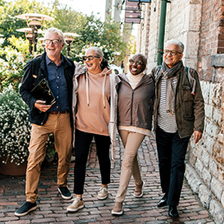 four older friends enjoying a walk outdoors