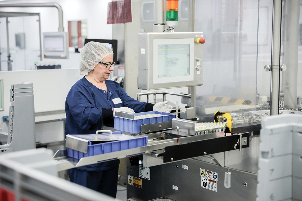 worker at vaccine cartridge manufacturing plant