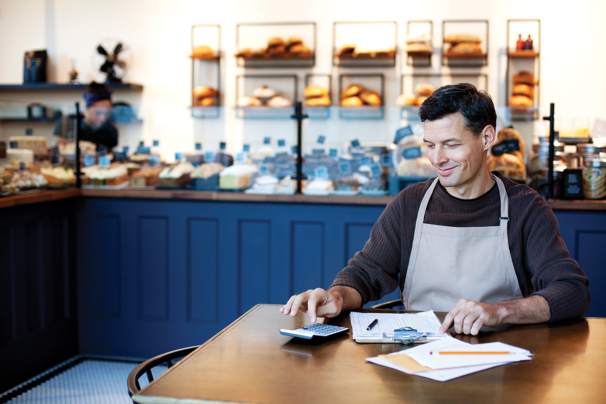 small businees owner doing accounting in bakery