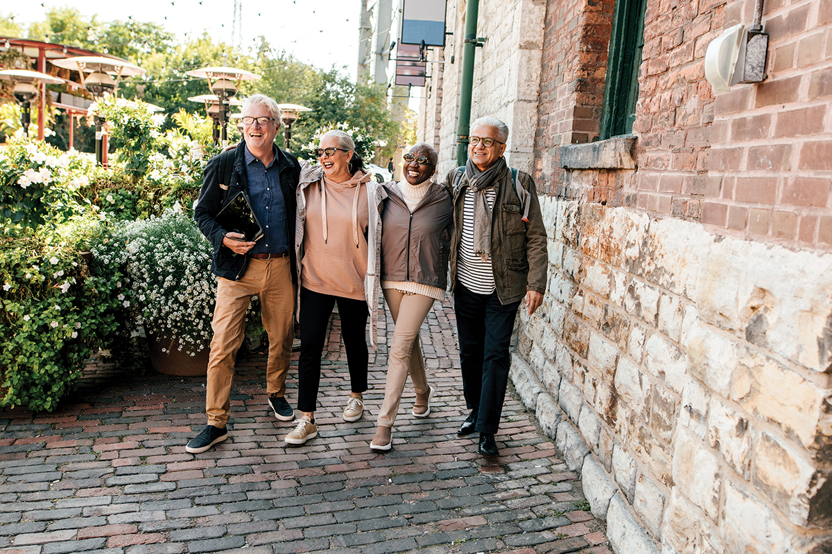 four older friends enjoying a walk outdoors